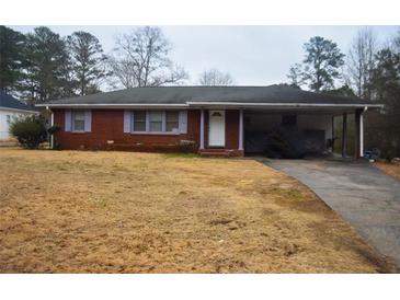 Brick ranch house with attached carport and mature trees at 4751 Brownsville Rd, Powder Springs, GA 30127