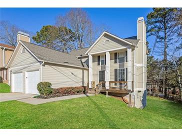 Charming two-story home with neutral siding, manicured lawn, and inviting front porch at 5541 Panola Pl, Lithonia, GA 30058