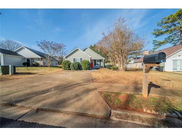 Cute ranch home with a driveway and well-maintained lawn at 540 Lakecourt Dr, Mcdonough, GA 30253