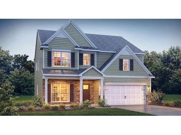 Two-story house with gray siding, stone accents, and a two-car garage at 13550 Whitman Se Ln, Covington, GA 30014