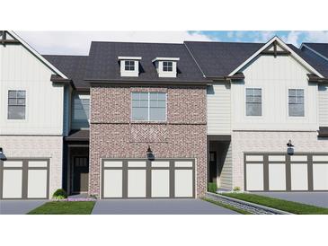 Brick front elevation of a two-story townhome with a two-car garage at 262 Depot Landing Rd, Auburn, GA 30011