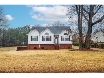 Brick and white ranch home with attached garage and landscaped yard at 2832 Fieldstone Se Dr, Conyers, GA 30013