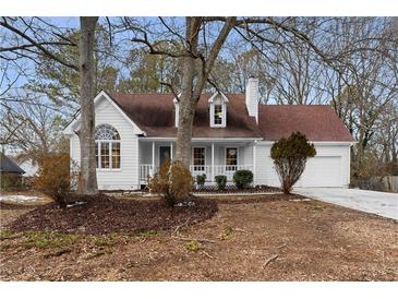 Charming one-story house with white siding, red roof, and mature trees at 495 Ashley Way, Loganville, GA 30052