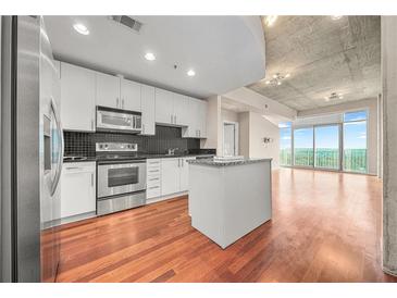 Modern kitchen with stainless steel appliances and granite countertops at 250 Pharr Rd # 1516, Atlanta, GA 30305