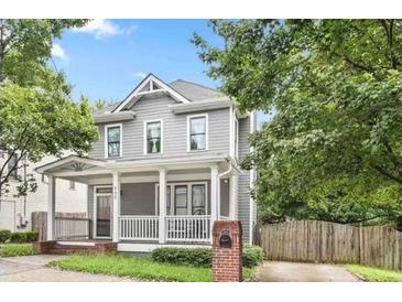 Gray two-story house with white porch and brick mailbox, nicely landscaped at 665 Windsor Sw St, Atlanta, GA 30310