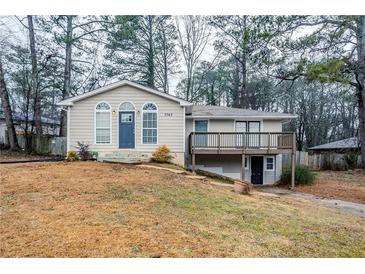 Tan house with blue door, deck, and landscaped yard at 3743 Turner Heights Dr, Decatur, GA 30032