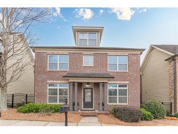 Brick two-story house with a front porch and landscaping at 4314 Elliott Way, Smyrna, GA 30082