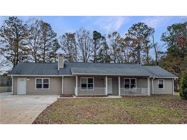 Ranch style home with front porch and large backyard at 165 Riverbend Dr, Covington, GA 30014