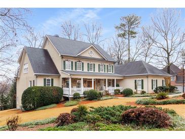 Charming two-story home with a welcoming front porch, green shutters, and beautifully landscaped yard at 2290 Spencers Way, Stone Mountain, GA 30087