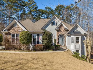 Stunning two-story home with stone accents and manicured lawn at 2311 Shoreline Pkwy, Villa Rica, GA 30180