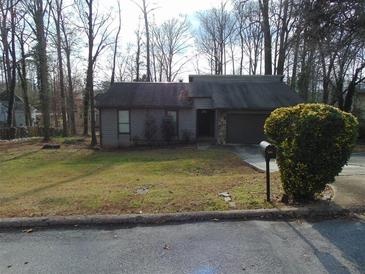 Charming single-story home featuring a well-maintained yard and an attached garage at 3321 Border Dr, Stone Mountain, GA 30087