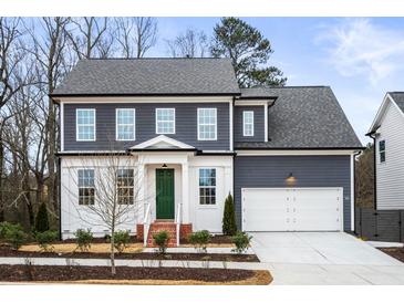Two-story house featuring gray siding, white accents, and a green front door at 386 10Th Unit 57 St, Auburn, GA 30011