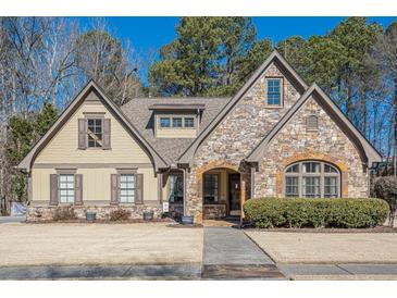Curb appeal abounds at this charming two-story home showcasing stone accents and a manicured lawn at 4824 Archer Pl, Acworth, GA 30101