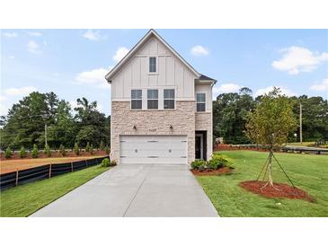 Charming new construction home featuring stone accents, a two-car garage and professionally landscaped lawn at 5756 Tillman Way, Powder Springs, GA 30127