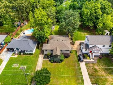Charming home with a spacious yard, mature trees, and inviting pool, perfect for outdoor enjoyment at 1770 Rockland Se Dr, Atlanta, GA 30316