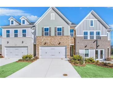 Three-unit townhome development showcasing attractive brick and siding exteriors at 5619 Tillman Way, Powder Springs, GA 30127