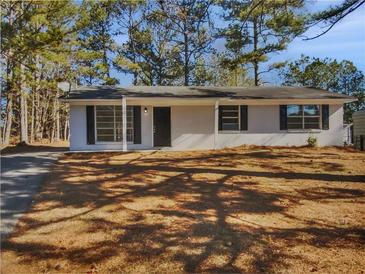 Newly renovated ranch home featuring a covered entry and spacious yard at 9129 Bent Pine Ne Ct, Covington, GA 30014