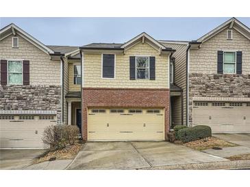 Charming townhouse featuring a brick facade and a convenient two-car garage at 162 Townview Dr, Woodstock, GA 30189