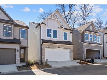 Two-story home with gray siding, stone accents, and a two-car garage at 714 Smokey Quartz Way, Kennesaw, GA 30144