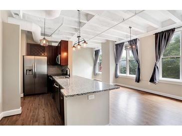 Modern kitchen with island and stainless steel appliances at 32 Peachtree Nw St # 308, Atlanta, GA 30303