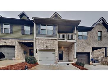 Brick front exterior of charming townhome with attached garage at 125 White Mountain Pass, Mcdonough, GA 30252