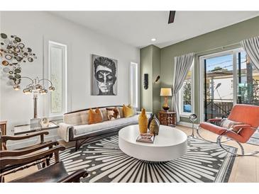 Bright living room with hardwood floors, modern decor, large windows, and a sliding glass door at 2199 Lenox Ne Rd # 13, Atlanta, GA 30324