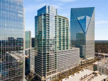 High-rise condominium building featuring floor-to-ceiling windows and sleek architectural design in a bustling city at 3325 Piedmont Ne Rd # 2407, Atlanta, GA 30305