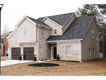 Two-story house with brick and siding, two-car garage, and landscaping at 3405 Summer Brooke Way, Union City, GA 30291