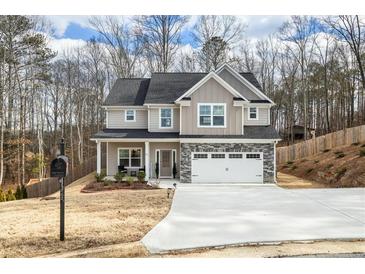 Two-story house with gray siding, stone accents, and a two-car garage at 66 Vicky Way, Douglasville, GA 30134