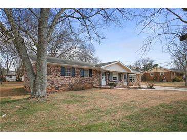 Brick ranch house with mature trees and a spacious yard at 1155 Casteel Rd, Powder Springs, GA 30127