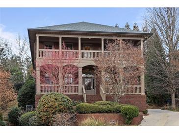 Two story brick home featuring covered porches on both levels at 560 Glenmanor Ct, Atlanta, GA 30328