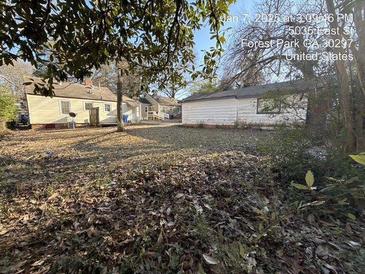 Spacious backyard featuring a detached garage, offering ample space for outdoor activities at 5039 East St, Forest Park, GA 30297