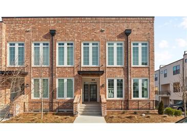 Brick townhome with white-framed windows and a front entrance at 137 Devore Rd, Alpharetta, GA 30009