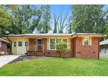 Brick ranch house with a landscaped lawn and driveway at 3141 Bellgreen Way, Decatur, GA 30032