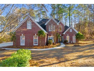 Brick house with landscaped yard and walkway at 3110 Haverhill Ne Cv, Conyers, GA 30012