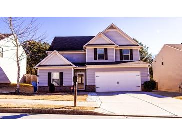 Two-story house with gray siding, white trim, and a two-car garage at 6636 Saint Jude Dr, Fairburn, GA 30213