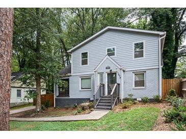 Two-story house with gray siding, a landscaped yard, and walkway at 1574 Mayflower St, Atlanta, GA 30311