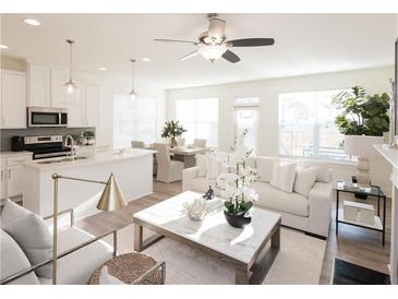 Bright and airy living room featuring modern decor, stylish furniture, and a ceiling fan at 1621 Aiden Way # 57, Conyers, GA 30013