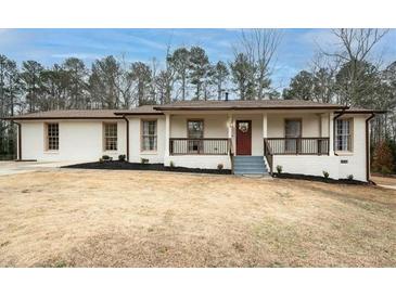 Charming single-story home with a brick facade, covered porch, and well-maintained landscaping at 3308 Wildwood Sw Dr, Marietta, GA 30060