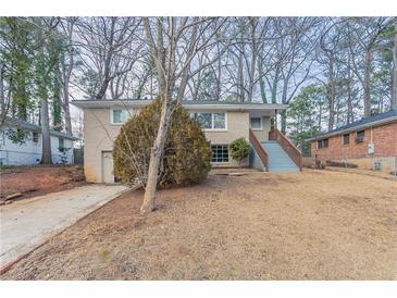 Ranch home with steps leading to the front entrance and a spacious yard at 2906 Monterey Dr, Decatur, GA 30032