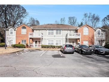 Brick front exterior of a two-story townhome building with parking at 4008 Orchard Hill Ter, Stone Mountain, GA 30083