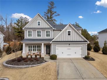 Two-story house with gray siding, white trim, and a landscaped yard at 6285 Vista Crossing Way, Cumming, GA 30028