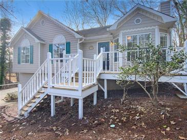 Ranch style home with white railings and a green door at 1508 Towne Harbor Ln, Woodstock, GA 30189