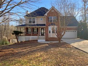 Brick two-story house with a front porch and attached garage at 169 Hunters, Mcdonough, GA 30253