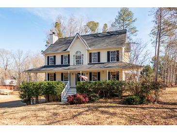 Two-story house with wraparound porch and landscaped yard at 40 Brompton Dr, Dallas, GA 30157