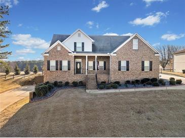 Brick house with a large front yard and attached garage at 8967 Midlothian Ct, Winston, GA 30187