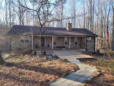 Ranch house with stone exterior, large deck, and walkway at 5295 Ridge Rd, Douglasville, GA 30134