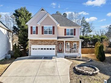 Two-story house with stone accents and a large driveway at 902 College Place Nw Ct, Kennesaw, GA 30144