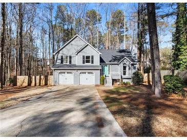 Gray two-story house with a three-car garage and landscaped yard at 118 Michael Ct, Dallas, GA 30157