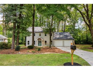 Charming two-story home featuring a lush front yard, and a two car garage at 2189 Wood Glen Se Ln, Marietta, GA 30067